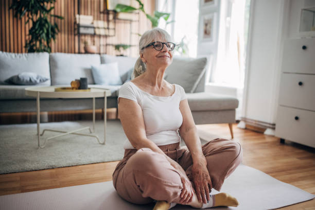 istock Senior woman doing yoga at home 1497877606