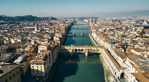 Aerial view of Ponte Vecchio bridge and Arno river in Florence Aerial view of Ponte Vecchio bridge and Arno river in Florence. High quality photo palazzo vecchio stock pictures, royalty-free photos & images