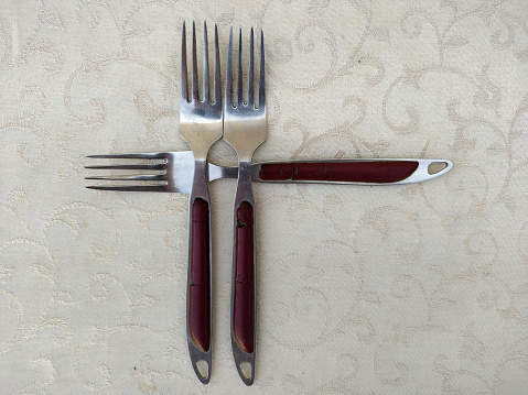 Photo of Several vintage forks arranged uniquely on the table