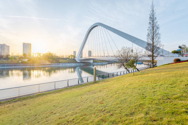The sunlight shines on the white bridge during sunrise