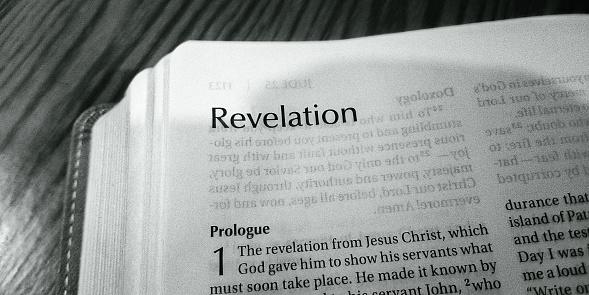 Opening verse of the King James Version of the Bible.  In the beginning God created the heaven and the earth.  Desaturated color.  Very Shallow Depth of Field, focus on the word beginning.