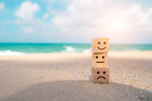 istock Smile face icon on a wooden cube for Customer service evaluation customer satisfaction level and satisfaction survey concept. 1497882206