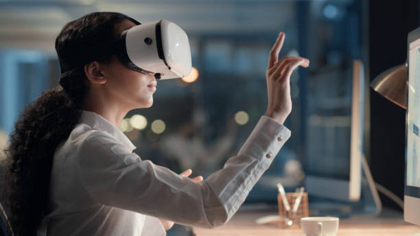 istock Business woman having a virtual meeting in the metaverse using a VR headset while sitting in her office at night. Future or futuristic corporate female using technology for an online conference 1497882540