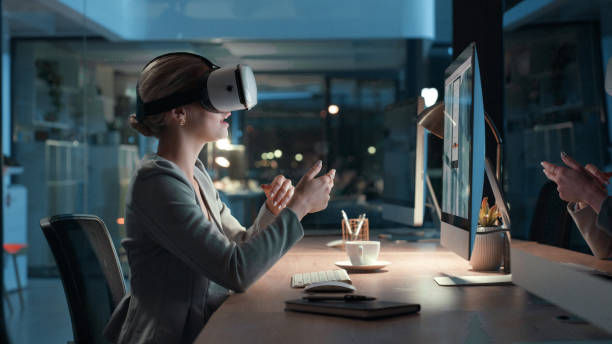 istock Virtual reality headset for video meeting online while working late at night in modern futuristic office. Young business woman using 3d, vr and wireless technology for innovation and new project idea 1497882563