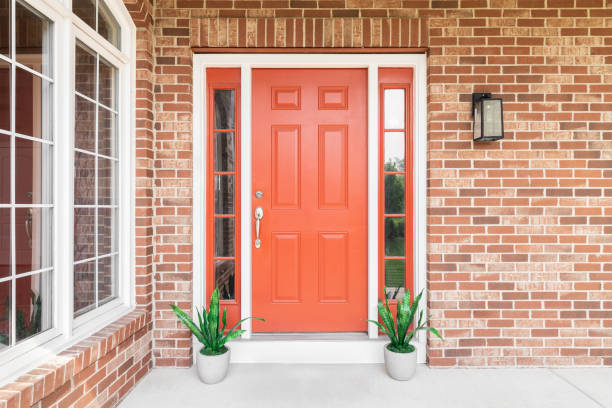 The red front door on a brick home.