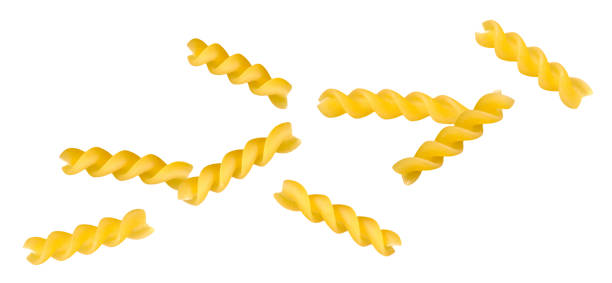 istock Italian fusilli pasta flying in space on a white background. Falling itallian spiral pasta close-up isolated on white background 1497885828