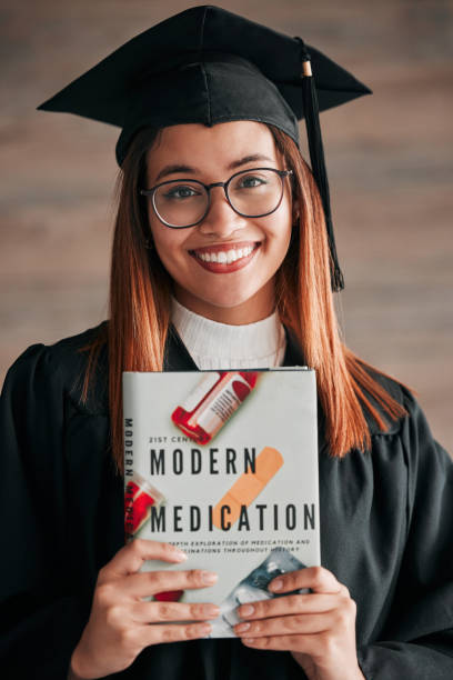 doctor graduate, woman portrait and medical textbook of a young student happy from graduation. learning book, happiness and excited female ready for university education with a smile from knowledge - medical student healthcare and medicine book education imagens e fotografias de stock