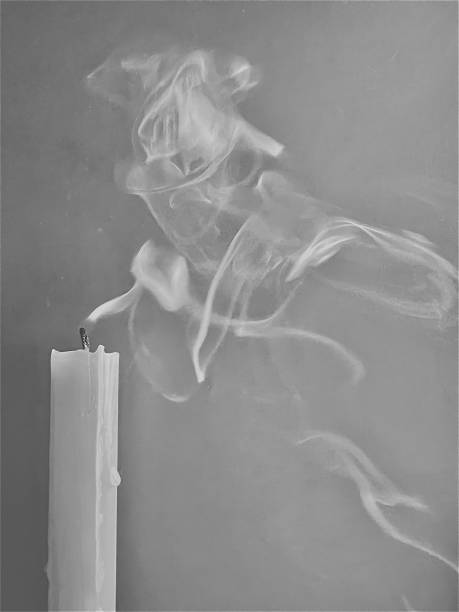 istock White candles have a gray background with smoke. 1497886677