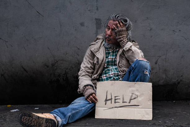 istock Homeless poverty man feeling despond hold signs for help. old pity man with beard begging for money. society's economic problem abandoned hopeless elderly. pauper people on home sleep on footpath. 1497887164