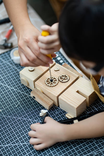istock a kid practice precision on hammering the nail 1497887249