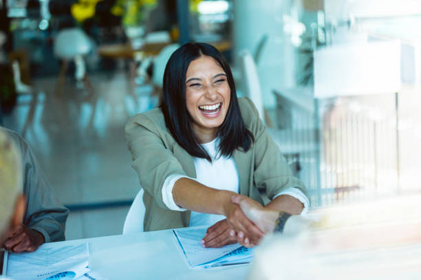 istock Businesswomen shaking hands across the table 1497888973
