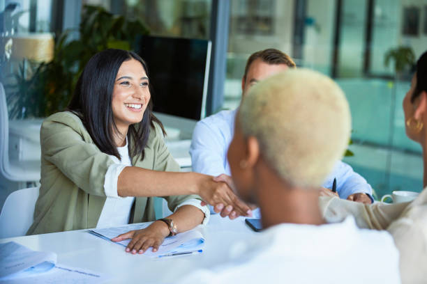 istock Businesswomen shaking hands across the table 1497889656