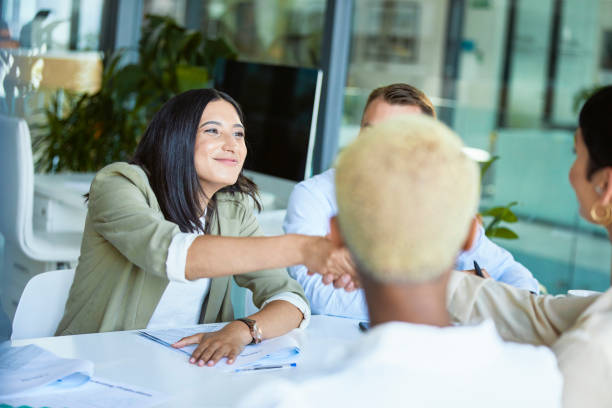 istock Businesswomen shaking hands across the table 1497889657