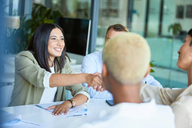 istock Businesswomen shaking hands across the table 1497890248