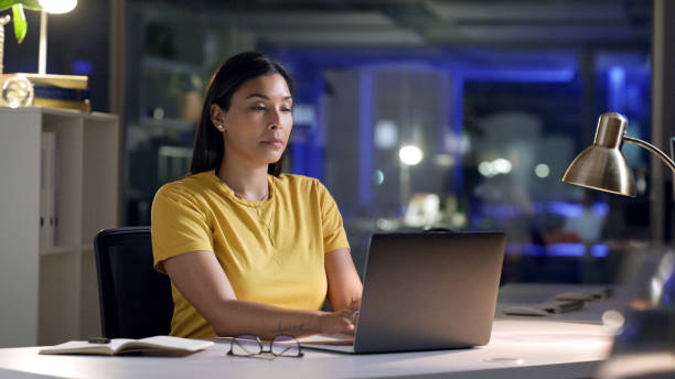 istock Working, computer and thinking of a woman at night planning a laptop research data project. Email, business idea and technology strategy of a tech worker in the dark with tech innovation at a desk 1497890319