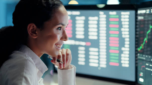 istock Smiling businesswoman working on data analytics, seo statistics and online marketing research while looking at monitor screen graphs inside a dark office. Corporate analyst analyzing software at work 1497891462