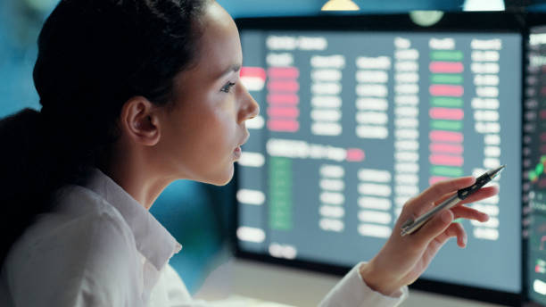 istock Professional female financial analyst watching and thinking on investment graph on computer screen. Businesswoman in corporate finance, studies stock market growth. Forex trader working at night. 1497891475