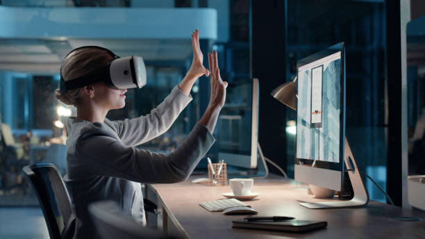 istock Working in metaverse with virtual reality headset in modern and futuristic office late at night. Business woman making hand gestures with fingers while using innovative 3d wireless vr device 1497891521