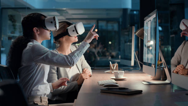 istock Wearing metaverse, virtual reality and cyber world vr goggles to interact, plan and analyze computer software, repair code and data. Two IT engineers with 3D headsets working late at night in office 1497891524