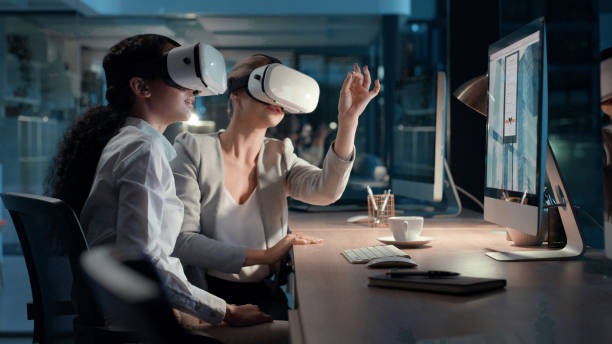 istock Woman in tech using VR equipment in a modern workplace. Digital business, and professional female workers collaborating and discussing virtual reality. Futuristic, 3D, and metaverse workplace. 1497891525