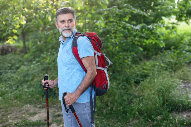 istock Mature man hiking in a forest 1497895078