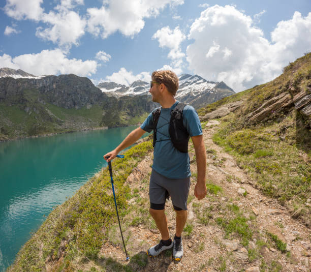 istock Man hiking in summer, Alpine lake view 1497895827