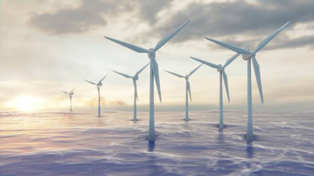 istock Camera pulls back through rotating blades of a wind turbine in an offshore wind farm in the sea against low sun. Green and renewable energy concept. Realistic high quality 3d animation. 1497895930