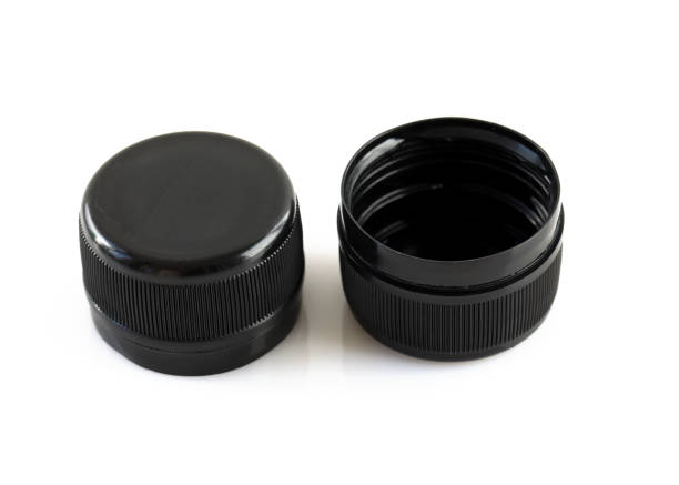 istock Two new black plastic caps on a white background. 1497897660