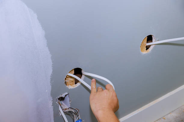 istock Work is being done safely on a construction site for a new house by an electrician installing a new current socket 1497897702