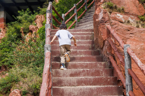 istock one boy travelling in mountains 1497898195