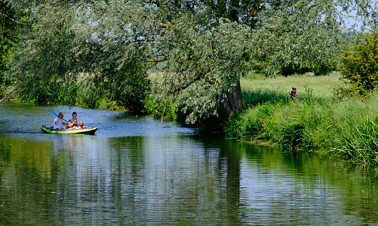 Dedham, Essex Suffolk Borders, United Kingdom, June 10, 2023. People boating and rowing on the River Stour in the Stour Valley between Dedham and Flatford Mill in Constable Country. Summer day outdoors