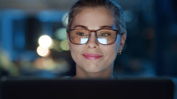istock Business woman working on a computer, reading and emails while working late at night. Happy, smiling and professional designer finishing tasks, meeting a deadline and doing overtime 1497899850