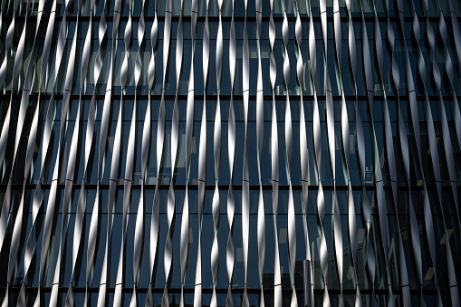 London, UK: The Monument Building located next to the monument memorial. Architectural detail of the front of the building. Landscape image.