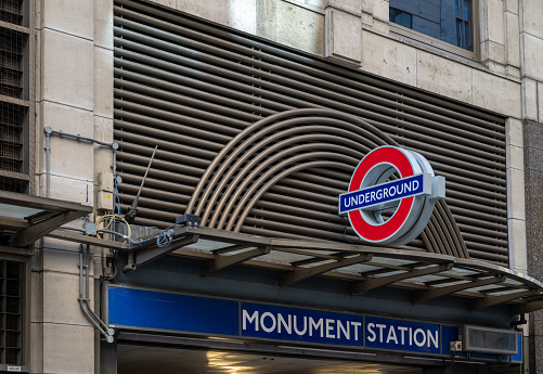 London, UK: Entrance to Monument tube station. A station on the London underground network. Name of the station and the London Underground logo.