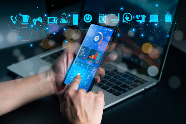 istock A woman inspects Internet of Things (IoT)-connected devices in her home using an augmented reality app on her phone. 1497903187