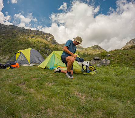 Traveler in the mountains near the tent