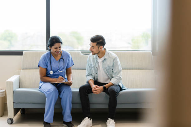 istock Female surgeon sits with young man to discuss test results 1497907394