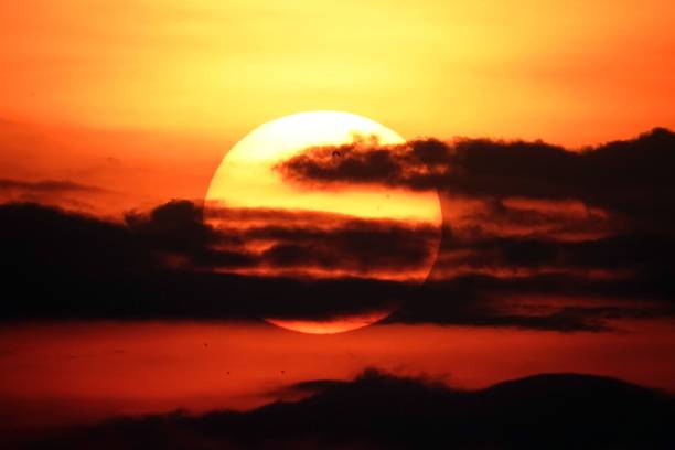 istock Stunning sunset with orange sky, illuminated by the setting sun and fluffy dark clouds 1497911179