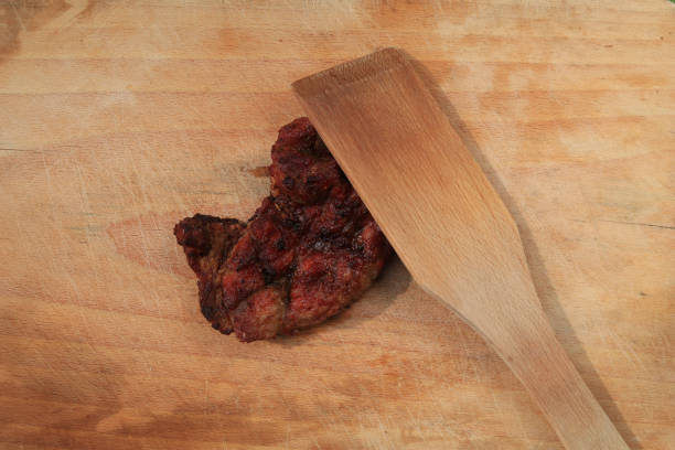 Food fried on charcoal grilled meat on a chopping board