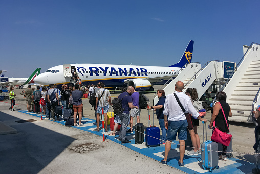 Bari, Italy. 07 04 2019. Travelers waiting in a queue to board a Ryanair plane.