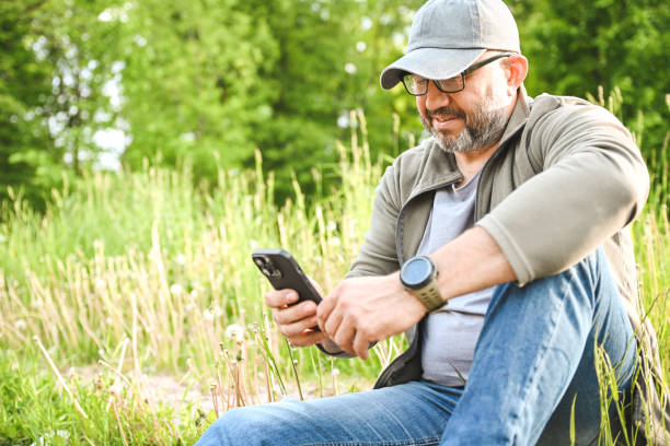 istock Mature adult man with mobile phone 1497915820