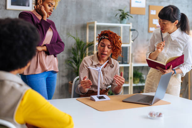 istock Diverse female coworkers discussing project prototype during work in office. 1497916655
