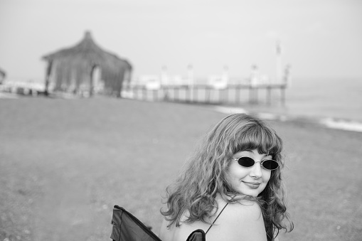 View of a woman with vintage style on the beach