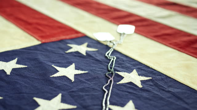 Dolly shot of vintage American flag with USA army, military dog tags. Concept fourth of July, 4th of July, Happy fourth of July USA independence day, celebration, Veteran's Day, Memorial Day, Holiday