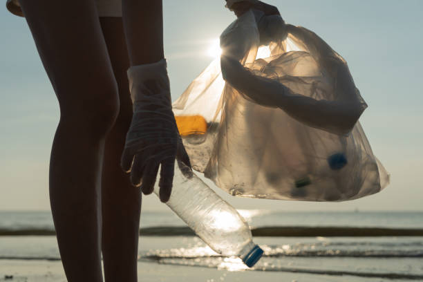 istock Save water. Volunteer pick up trash garbage at the beach and plastic bottles are difficult decompose prevent harm aquatic life. Earth, Environment, Greening planet, reduce global warming, Save world 1497921128