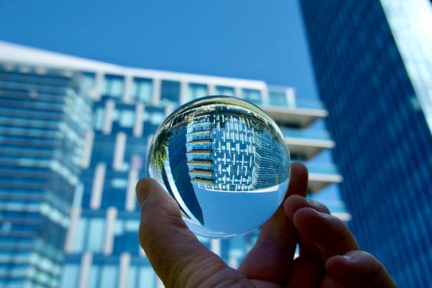 istock Hand holding crystal ball against modern buildings 1497923594