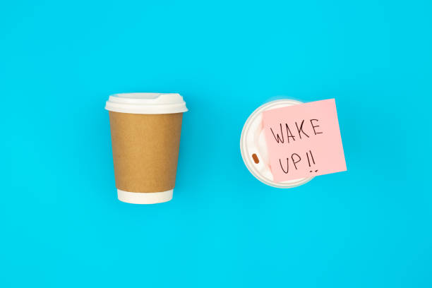 istock Paper disposable cups and paper reminder with text Wake up. 1497924193