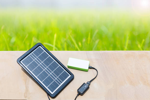 istock Portable solar cell panel with space on green garden background 1497926702