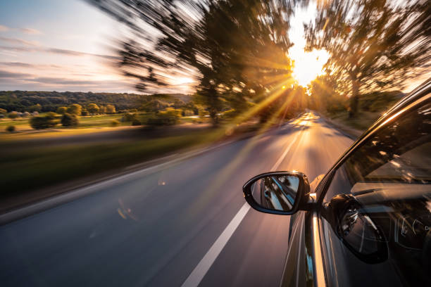 A car is driving on the highway, the environment is blurred