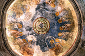 Frescoes with the faces of saints on the ceiling of the Church of St. Nicholas